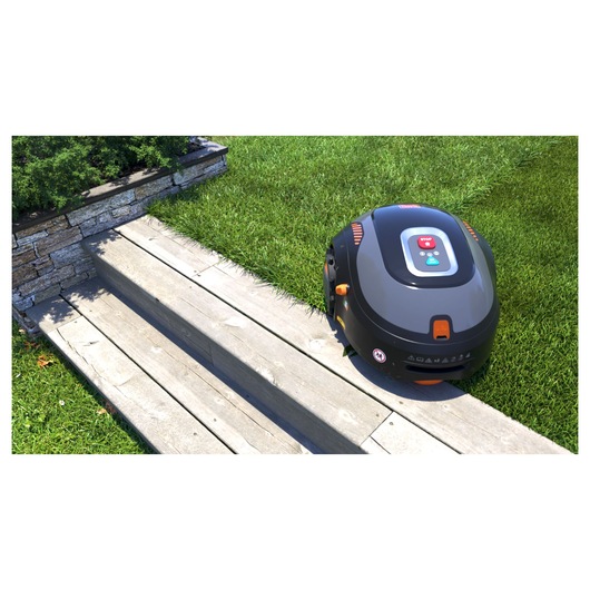 A BLACK+DECKER robotic lawn mower on a grassy garden near wooden steps and a stone border.