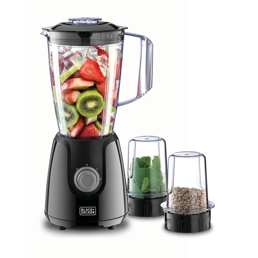 BLACK+DECKER blender model BX440 in black, filled with sliced fruits and ice in the main jar, shown alongside two smaller attachments containing green leaves and coffee beans.