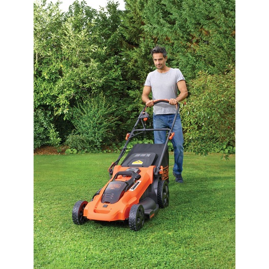 Photo of BLACKDECKER CLMA4820L2 lawn mower in use outdoors on a green lawn.