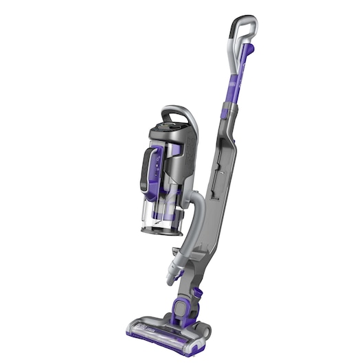 A cordless upright vacuum cleaner in grey and purple colors, featuring a transparent dust container and ergonomic handle, positioned on a white background.