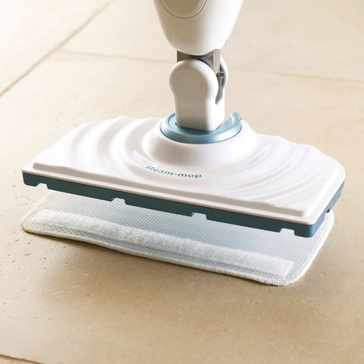 BLACKDECKER FSM1605 steam mop white and blue cleaning head on tile floor, side angle.