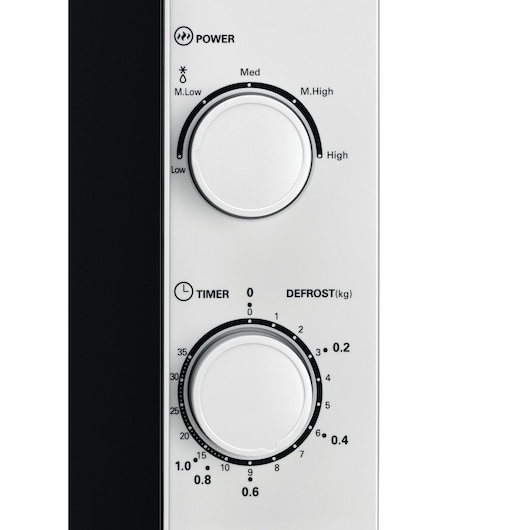 Close-up of the control panel on a BLACK+DECKER microwave oven, showing two white dials. The top dial is labeled Power and displays settings for Low, M.Low, Med, M.High, and High. The lower dial is labeled Timer and Defrost, with a scale for minutes and kilograms.