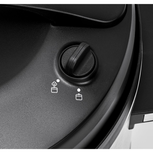 BLACKDECKER PCP1010 pressure cooker control knob close-up, showing two function icons on black surface.