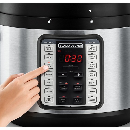 Photo of a hand pressing the SLOW COOK button on a BLACK+DECKER electric pressure cooker, SKU PCP1010, front view.