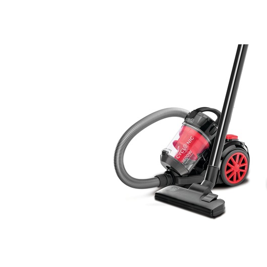 A BLACK+DECKER cyclonic vacuum cleaner with a transparent dust container, black and red design, hose and floor nozzle attachment.